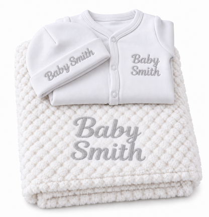 White set with grey embroidery showing personalised blanket, sleepsuit and hat on a white background.