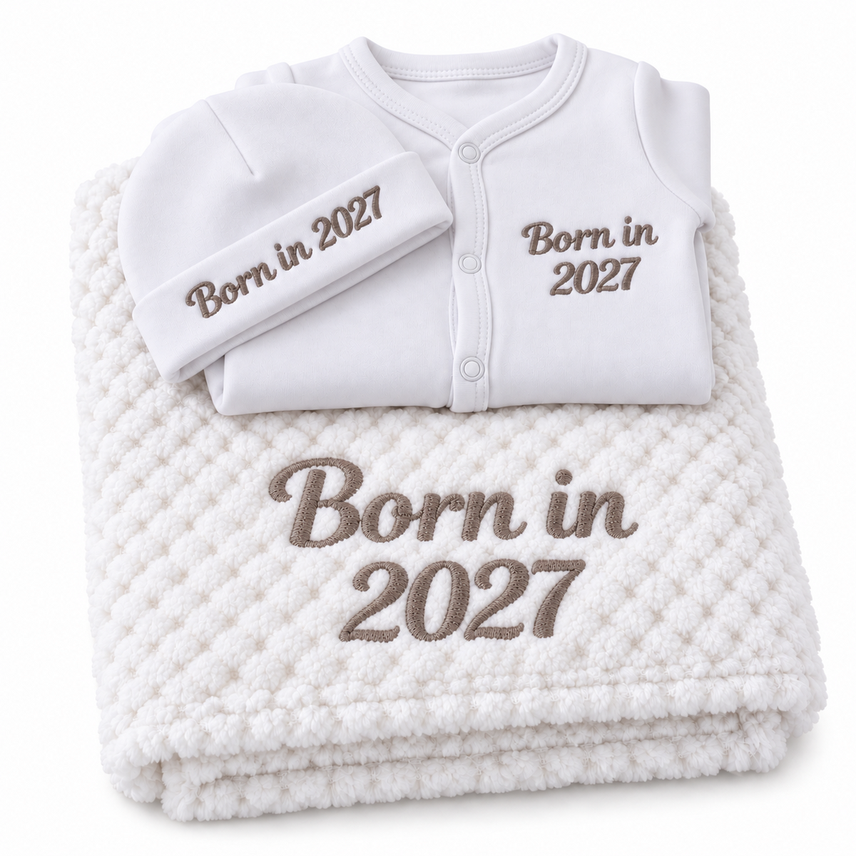 White set with taupe embroidery showing personalised blanket, sleepsuit and hat on a white background.