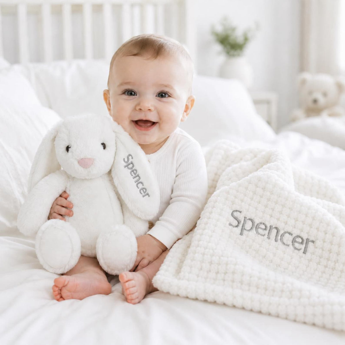 Baby with the white personalised bunny and waffle blanket set
