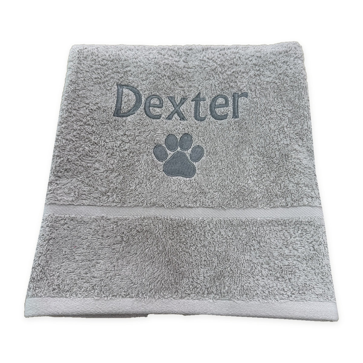 Grey cotton dog hand towel personalised with Dexter and a paw print
